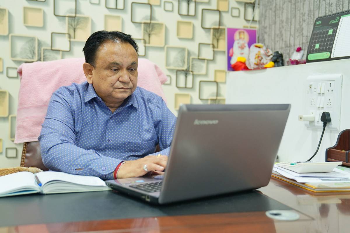 Mr. Hasmukh Chimanbhai Patel working at his desk